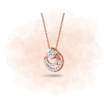 Rose gold necklace with a diamond pendant on a soft pink background